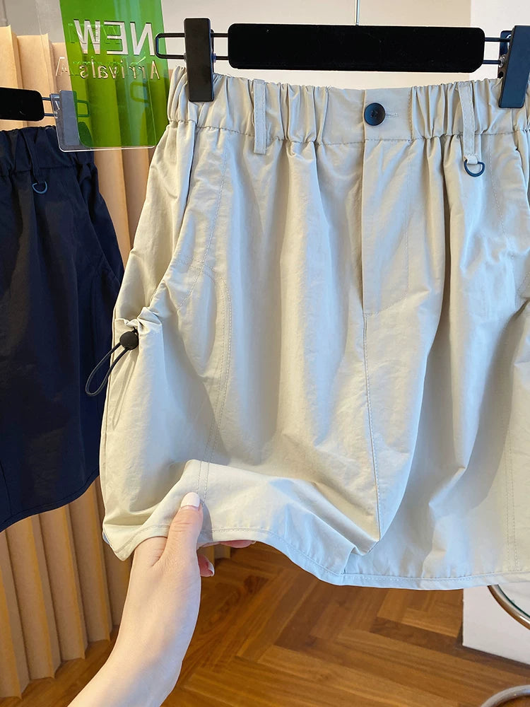 Chân Váy Ngắn Workwear Cạp Cao – Dáng Bao Mông Chống Lộ, Hè 2026